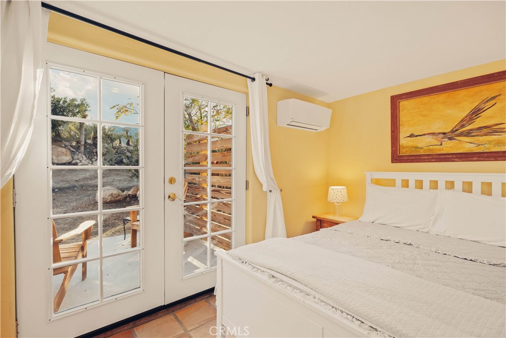 62238 Rincon Road Joshua Tree, CA 92252 - Photo 16 of 60 a bedroom with a bed and a window