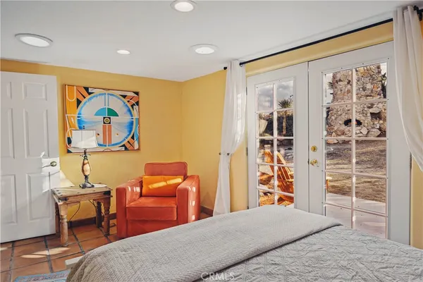 a bedroom with a bed and a painting on the wall