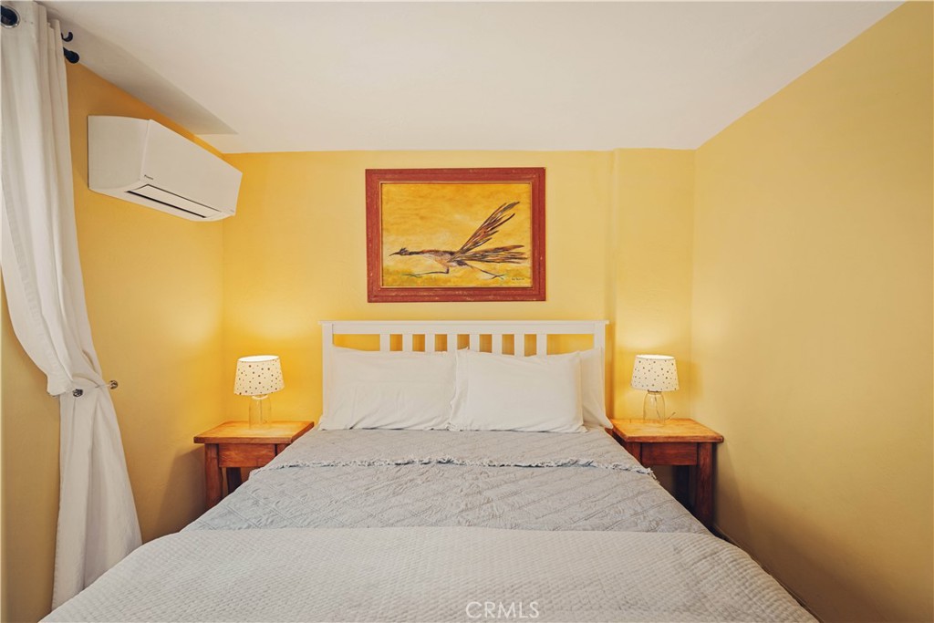 62238 Rincon Road Joshua Tree, CA 92252 - Photo 18 of 60 a bedroom with a bed and a painting on the wall