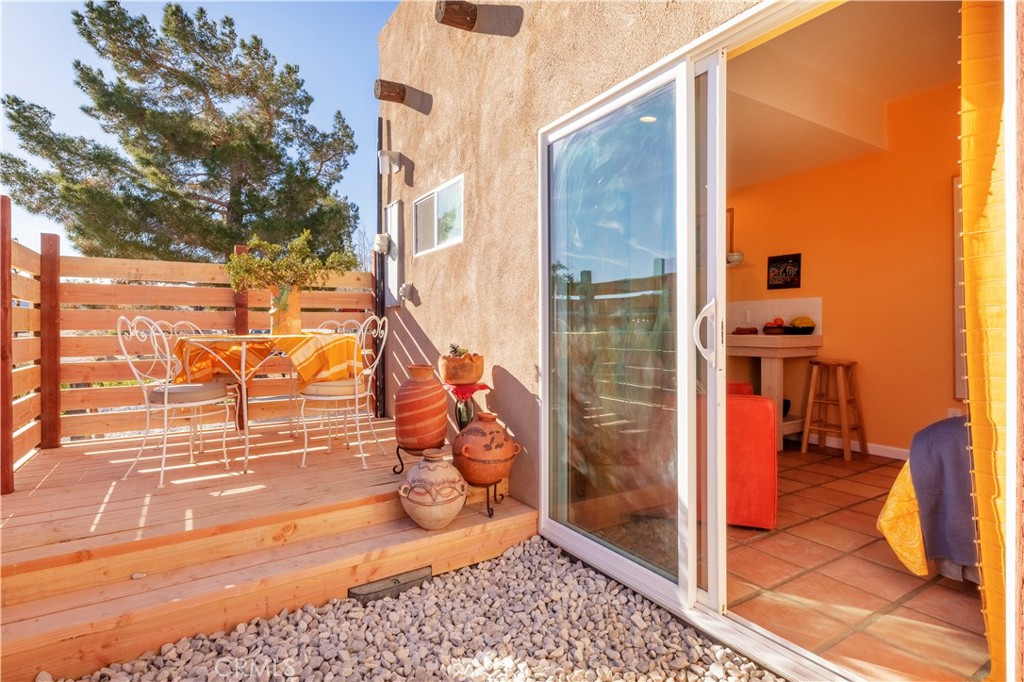 62238 Rincon Road Joshua Tree, CA 92252 - Photo 29 of 60 a view of a porch with a floor to ceiling window