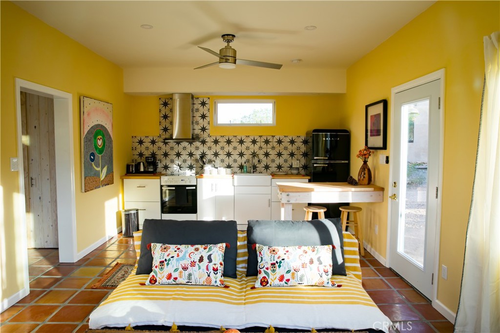 62238 Rincon Road Joshua Tree, CA 92252 - Photo 30 of 60 a bedroom with a bed and wooden floor