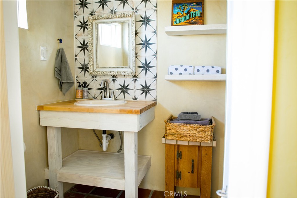 62238 Rincon Road Joshua Tree, CA 92252 - Photo 37 of 60 a bathroom with a sink a mirror and a window