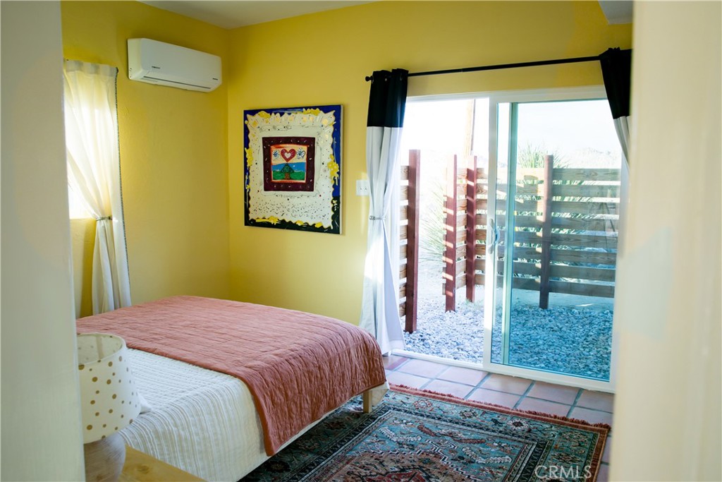 62238 Rincon Road Joshua Tree, CA 92252 - Photo 38 of 60 a bedroom with a bed and a window