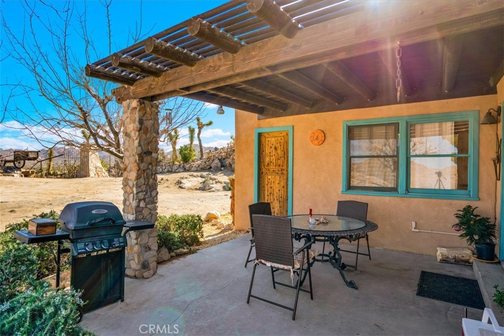 62238 Rincon Road Joshua Tree, CA 92252 - Photo 45 of 60 a patio with a table and chairs and potted plants
