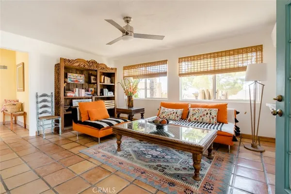 a living room with furniture a rug and a large window