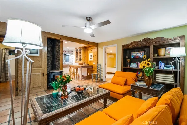 a living room with patio furniture and a fireplace