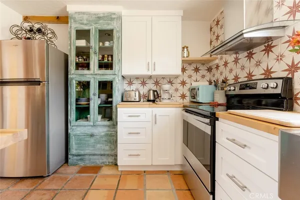 a kitchen with stainless steel appliances kitchen island granite countertop a refrigerator and a stove