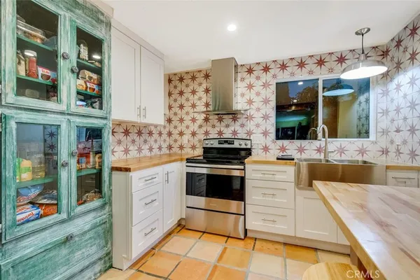 a kitchen with stainless steel appliances granite countertop a stove and cabinets
