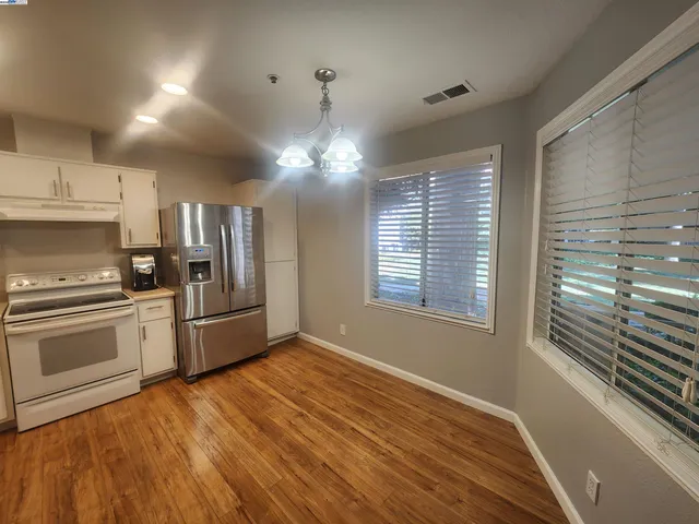 a kitchen with stainless steel appliances a refrigerator sink and stove