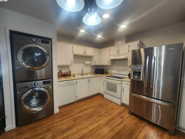 a kitchen with a refrigerator and a stove top oven