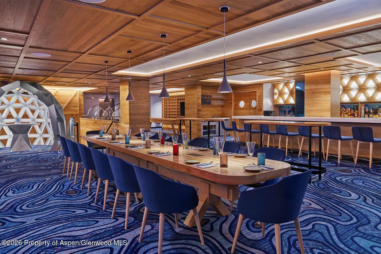 550 South Spring Street, Unit F72 Aspen, CO 81611 - Photo 13 of 16 a view of a dining room with furniture window and wooden floor