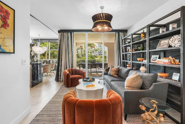 a living room with stainless steel appliances furniture and a view of kitchen
