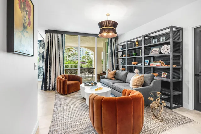 a kitchen with stainless steel appliances granite countertop a refrigerator a sink and white cabinets