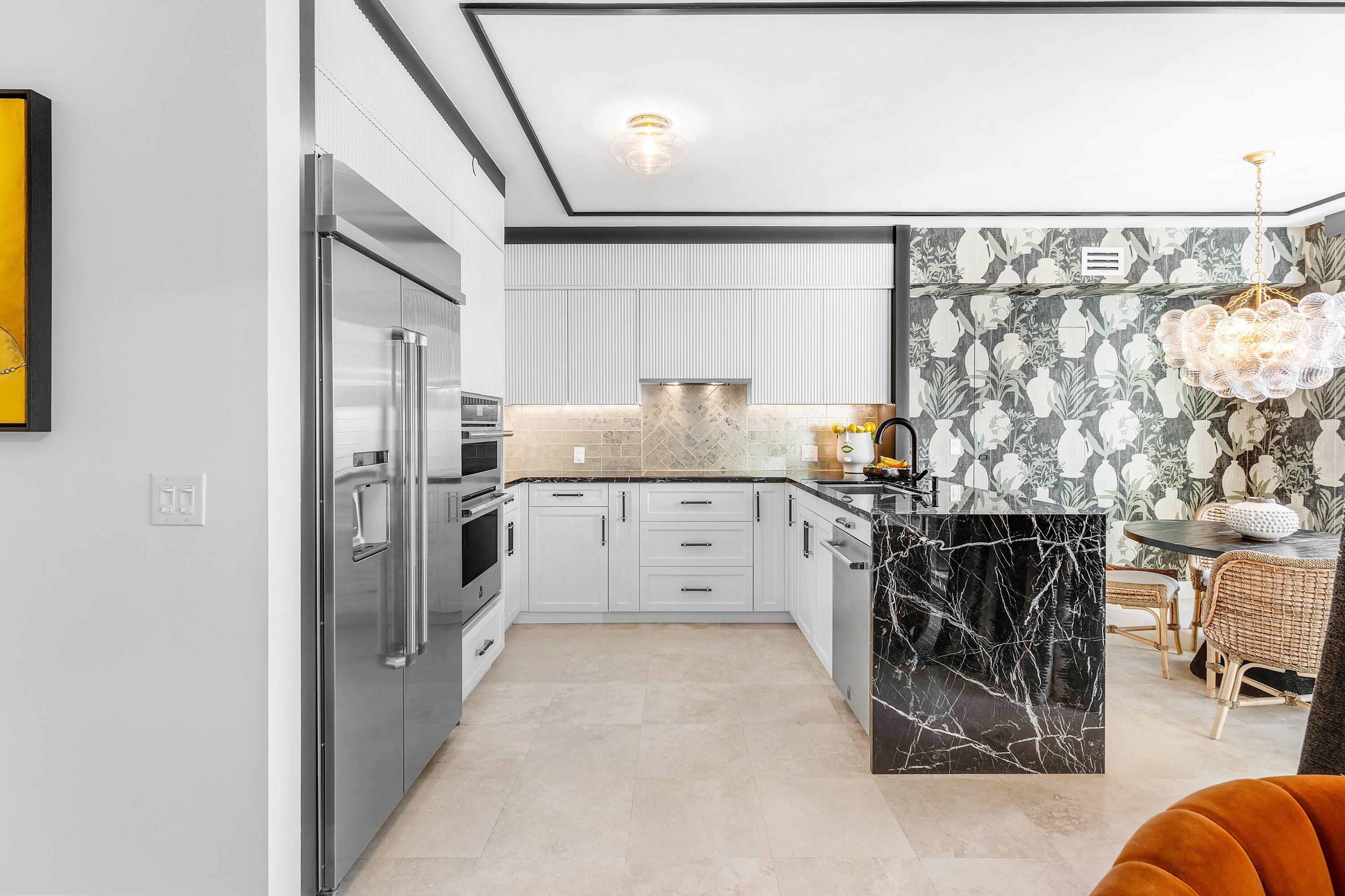 3700 South Ocean Boulevard, Unit 202 Highland Beach, FL 33487 - Photo 19 of 75 a kitchen with stainless steel appliances kitchen island granite countertop a refrigerator and a stove top oven
