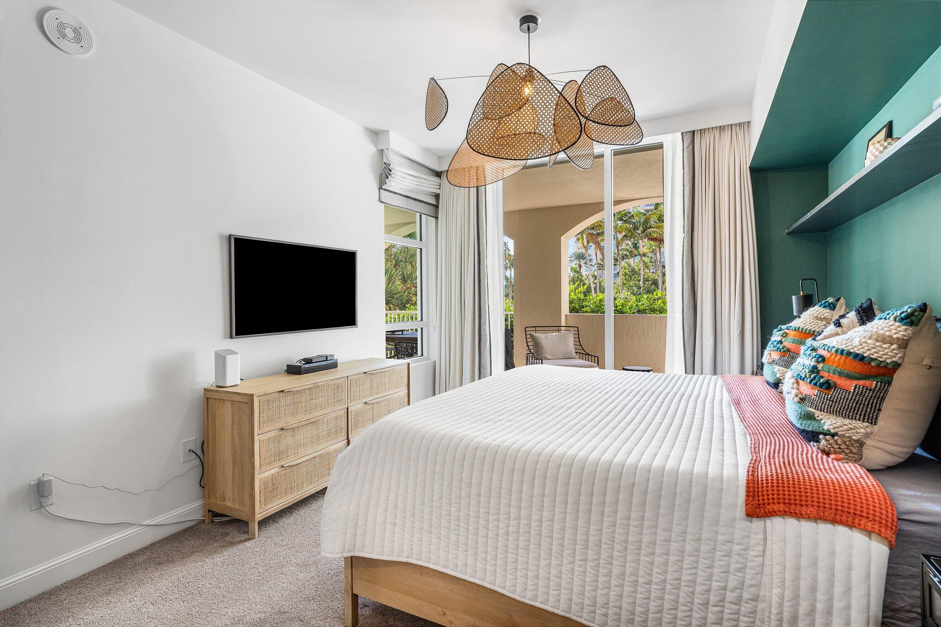 3700 South Ocean Boulevard, Unit 202 Highland Beach, FL 33487 - Photo 24 of 75 a bedroom with furniture and flat screen tv