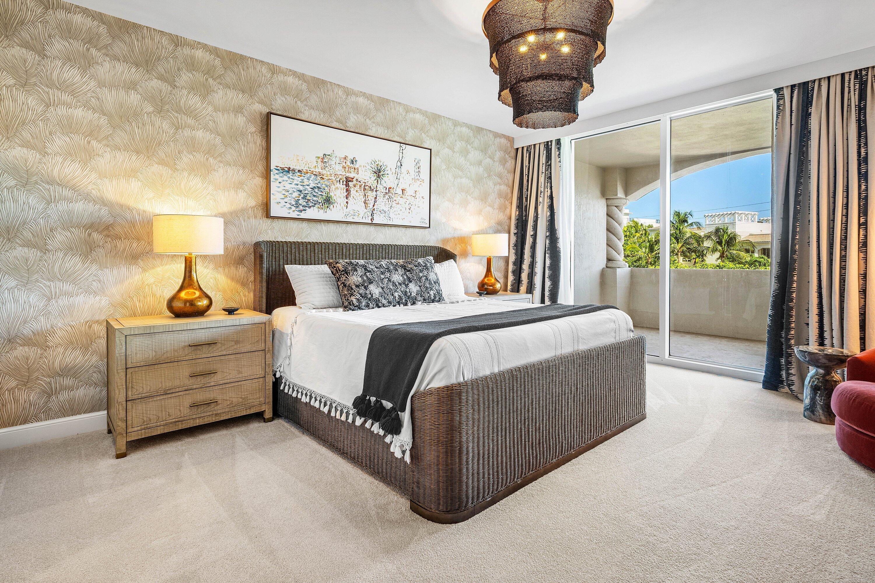 3700 South Ocean Boulevard, Unit 202 Highland Beach, FL 33487 - Photo 26 of 75 a bed room with a bed and a chandelier