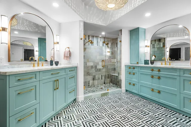 a bathroom with a double vanity sink mirror and shower
