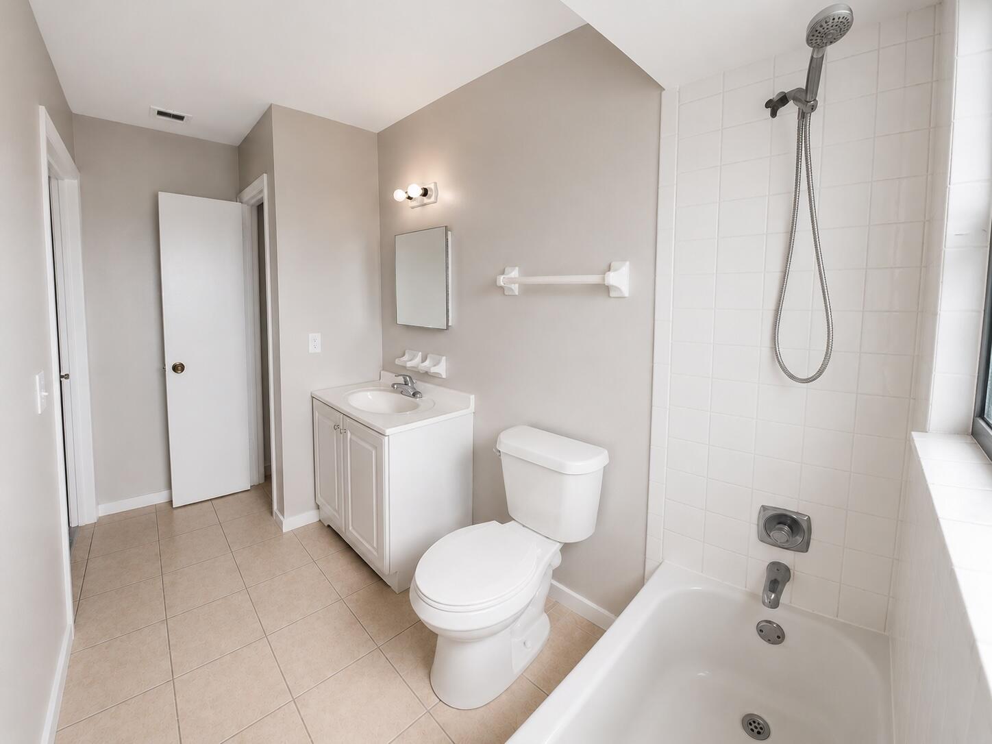 1794 Juno Road, Unit 2 North Palm Beach, FL 33408 - Photo 7 of 9 a bathroom with a toilet sink shower and mirror