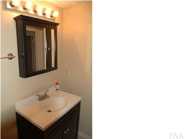 7150 Plantation Road, Unit 413 Pensacola, FL 32504 - Photo 13 of 21 Vanity has storage below