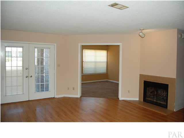 7150 Plantation Road, Unit 413 Pensacola, FL 32504 - Photo 5 of 21 New paint, laminate floors, and a fireplace create a lovely living room