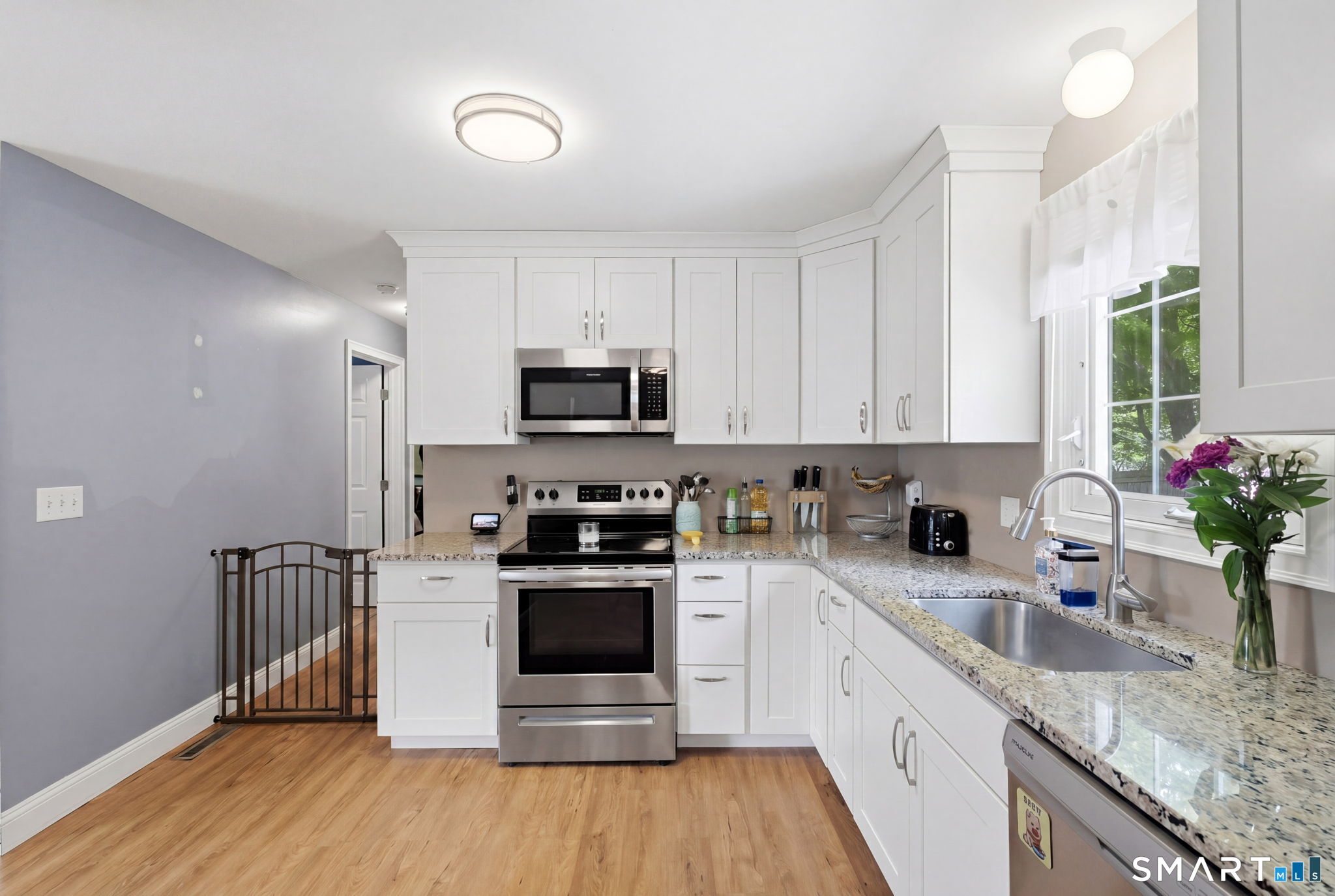 71 Smith Street Putnam, CT 06260 - Photo 25 of 25 a kitchen with sink a microwave and cabinets