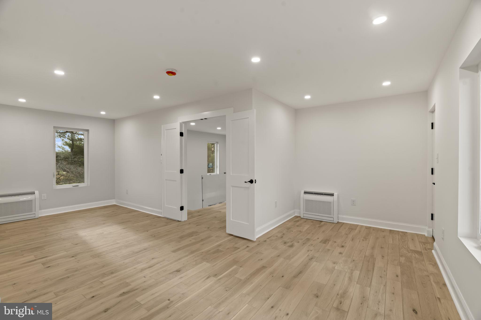 300 Witmer Road Horsham, PA 19044 - Photo 26 of 37 a view of an empty room with wooden floor and a window