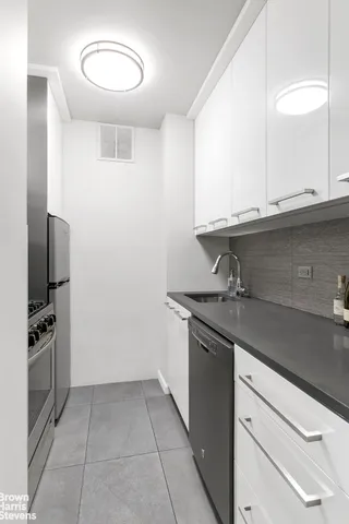 a living room with furniture a large window and a table