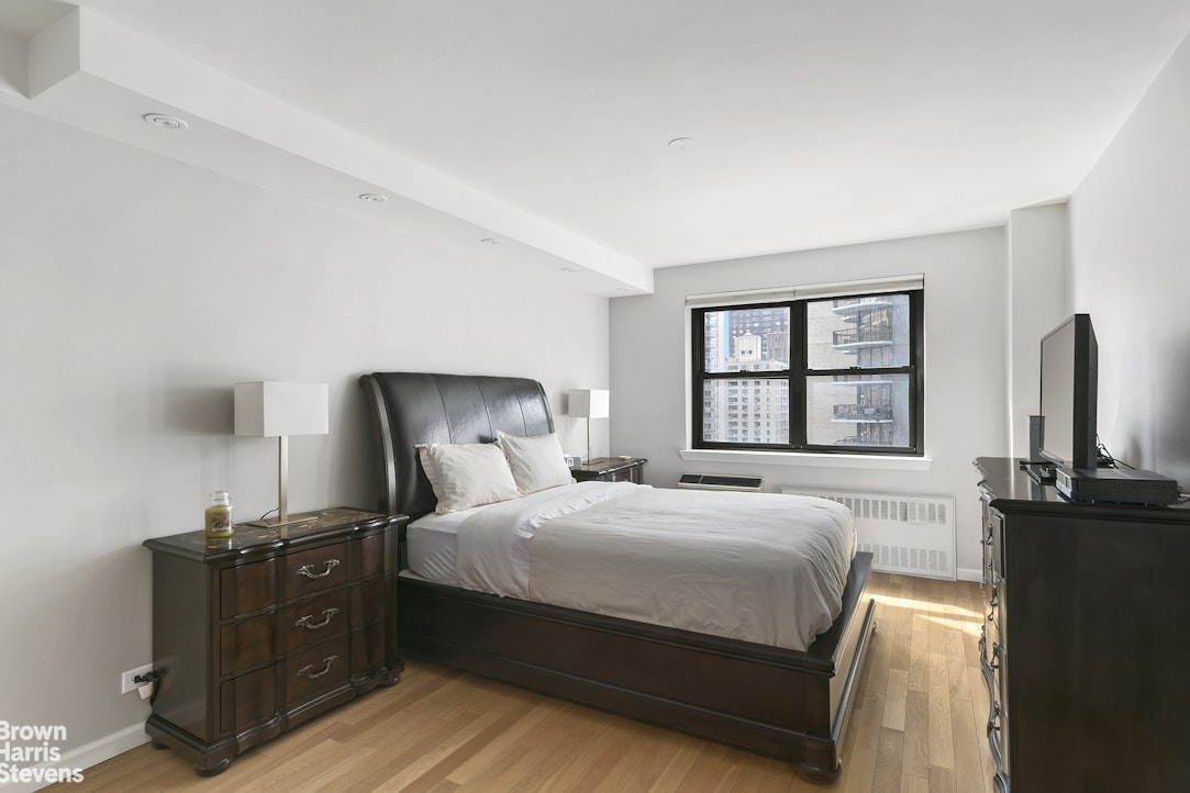 357 East 57th Street, Unit 11E Manhattan, NY 10022 - Photo 4 of 7 a bedroom with a bed and a large window