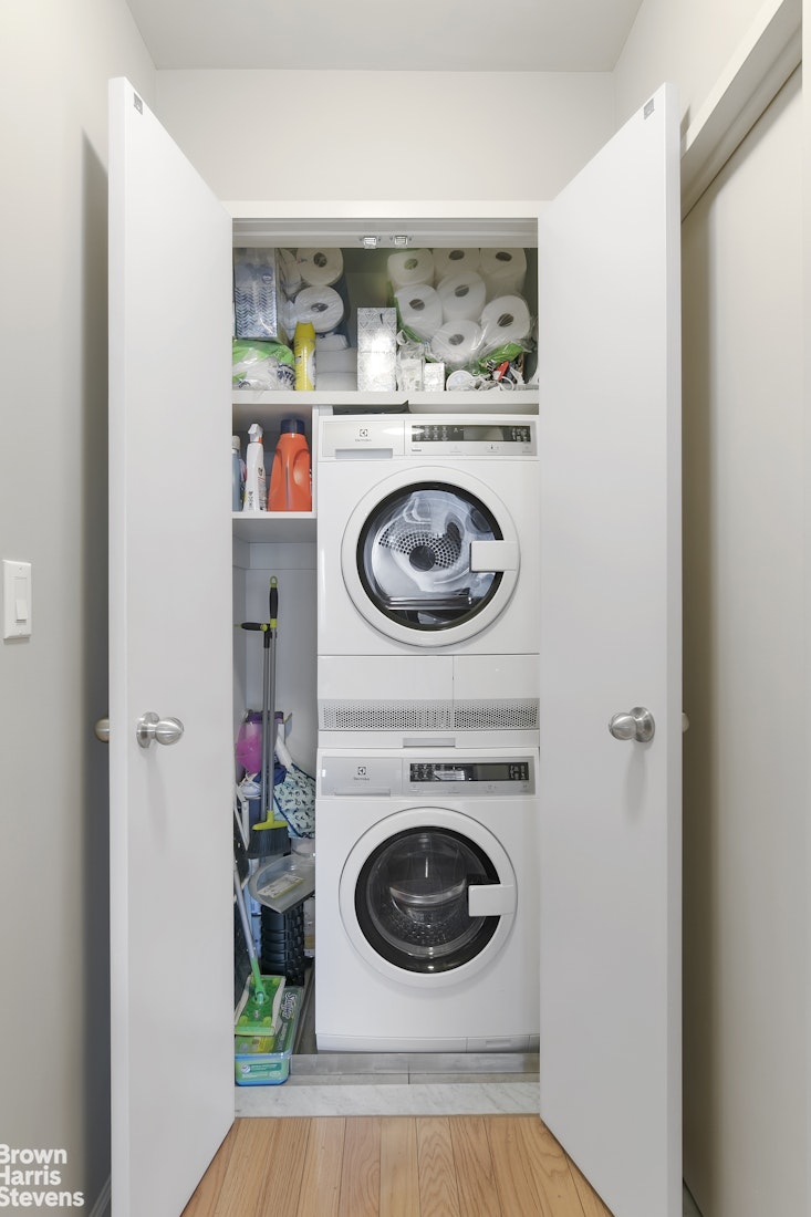 357 East 57th Street, Unit 11E Manhattan, NY 10022 - Photo 6 of 7 a view of washer and dryer in a utility room