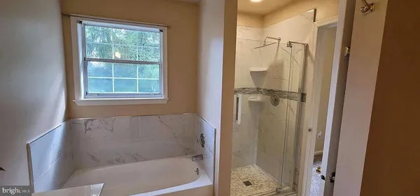 a bathroom with a glass shower door