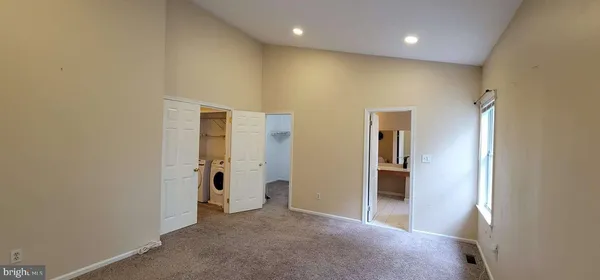 a view of a hallway with wooden shelves