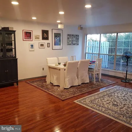 a living room with a rug floor and a table