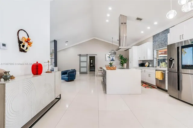 a kitchen with kitchen island and stainless steel appliances