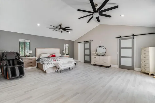 a bedroom that has a bed and a chandelier