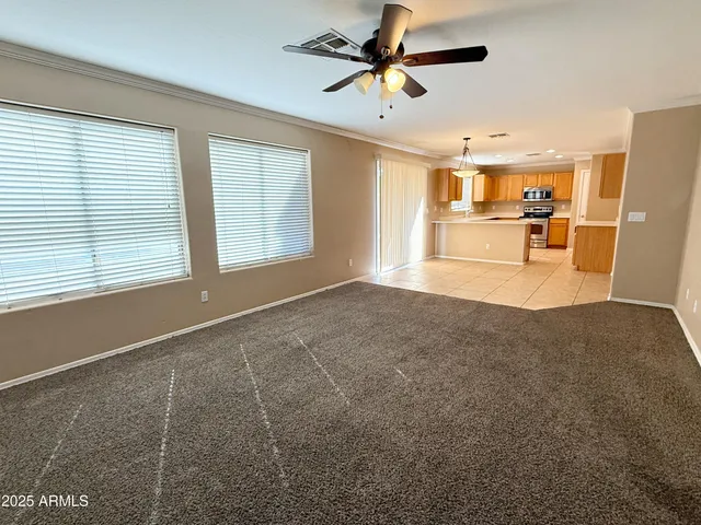 a view of empty room with wooden floor and window