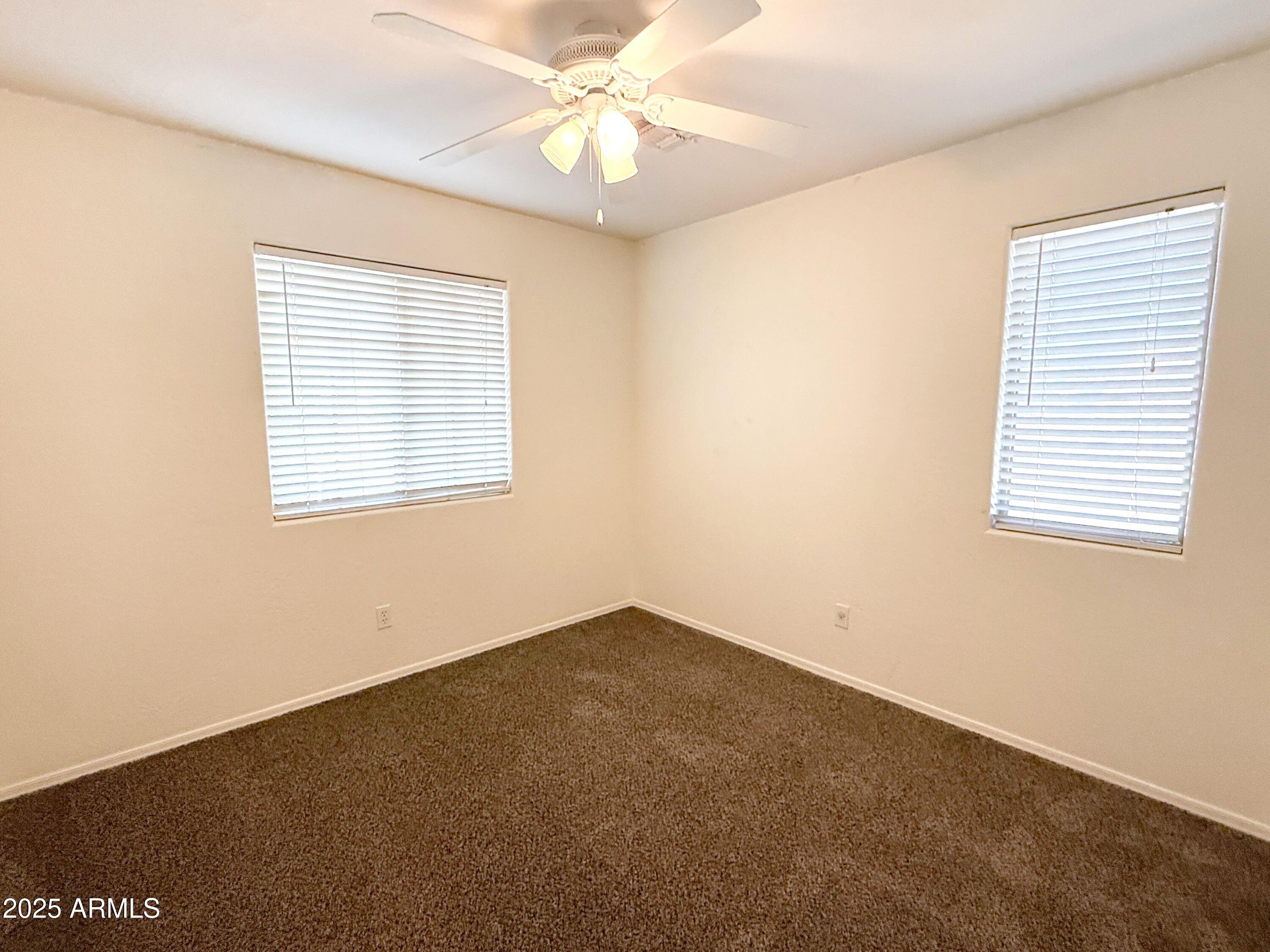 3363 East Flamingo Court Gilbert, AZ 85297 - Photo 20 of 29 an empty room with a window and a ceiling fan