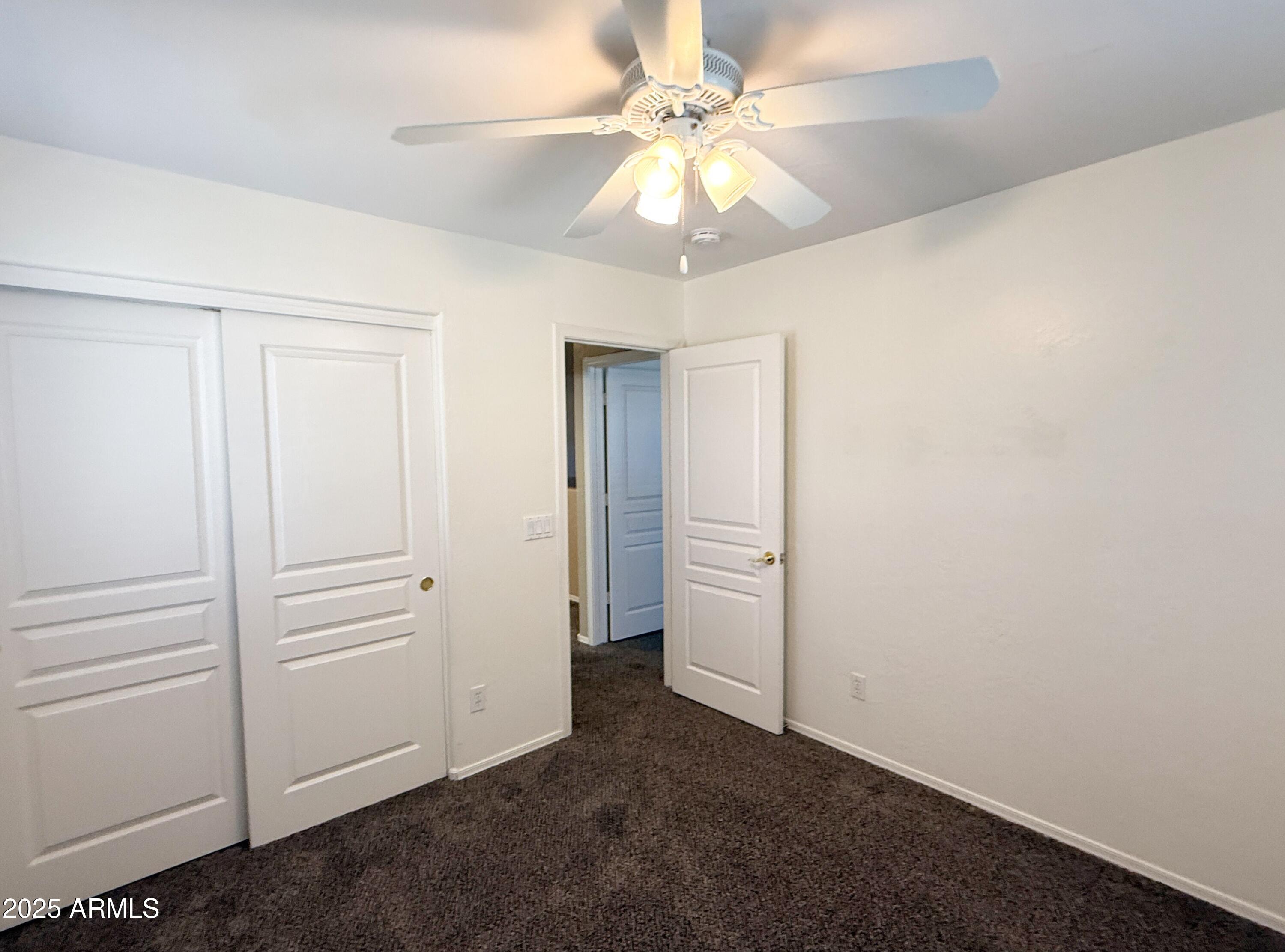 3363 East Flamingo Court Gilbert, AZ 85297 - Photo 21 of 29 an empty room with a ceiling fan