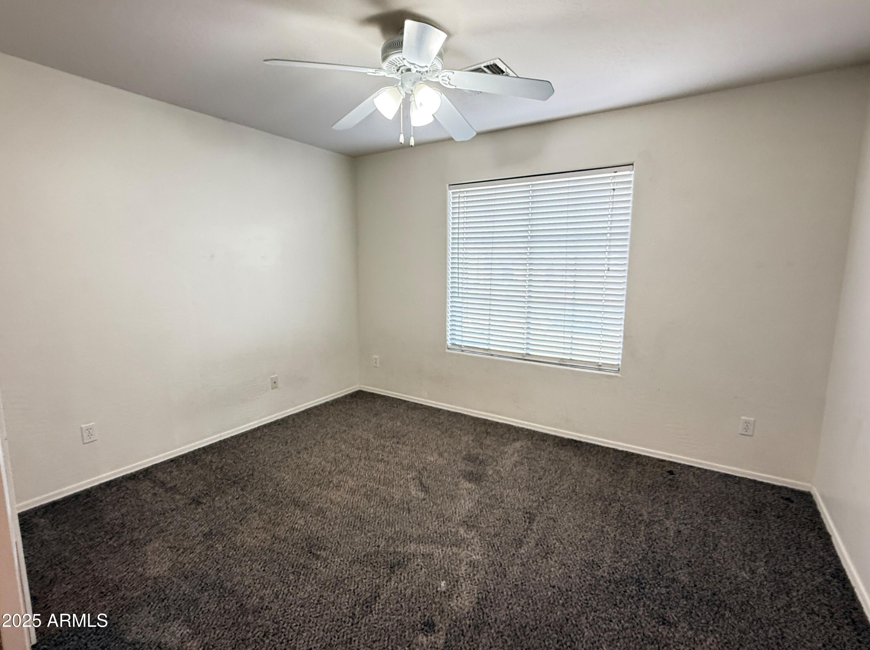 3363 East Flamingo Court Gilbert, AZ 85297 - Photo 22 of 29 an empty room with a window and a ceiling fan