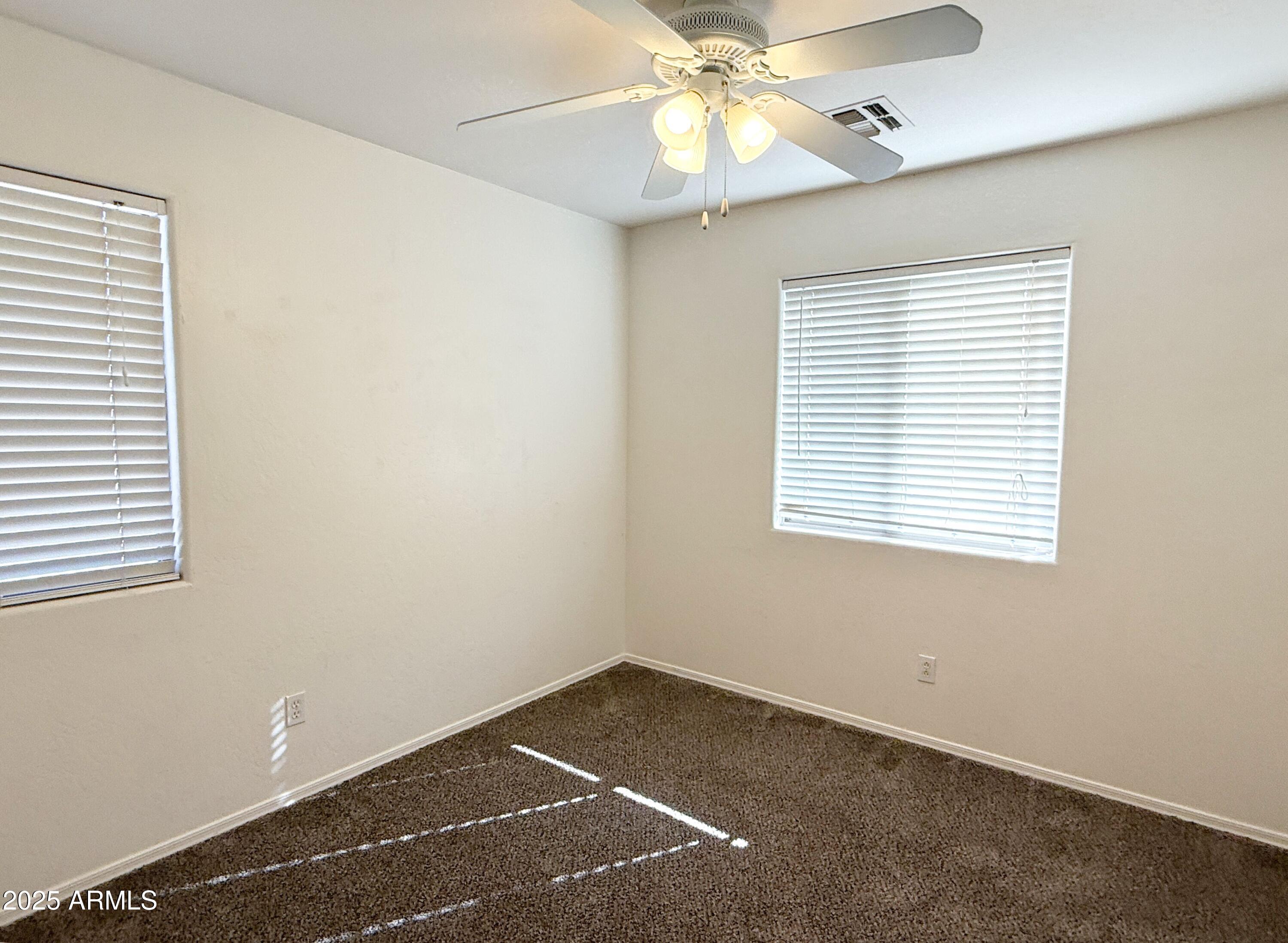3363 East Flamingo Court Gilbert, AZ 85297 - Photo 25 of 29 an empty room with a window and a fan