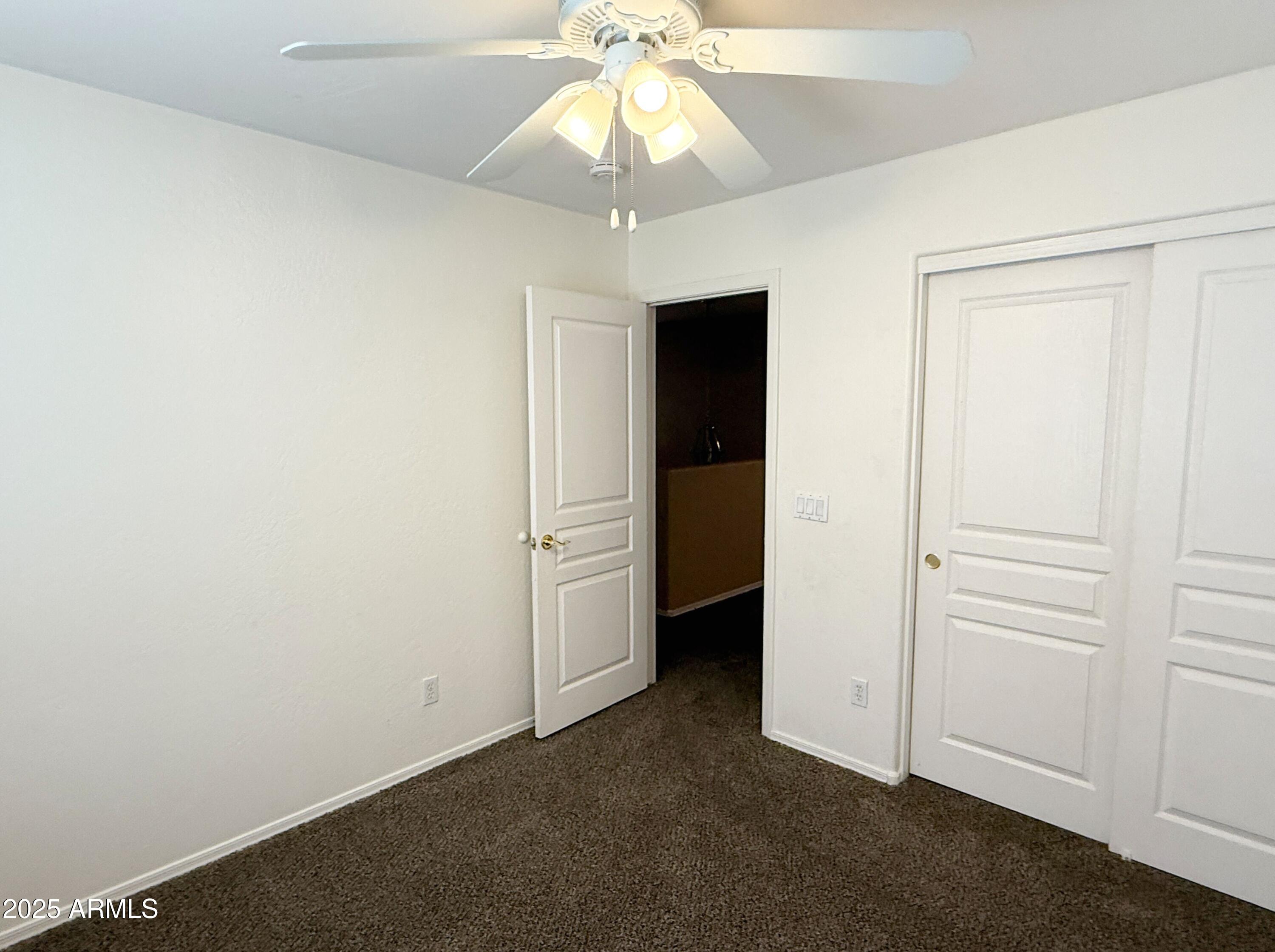 3363 East Flamingo Court Gilbert, AZ 85297 - Photo 26 of 29 an empty room with a ceiling fan and closet