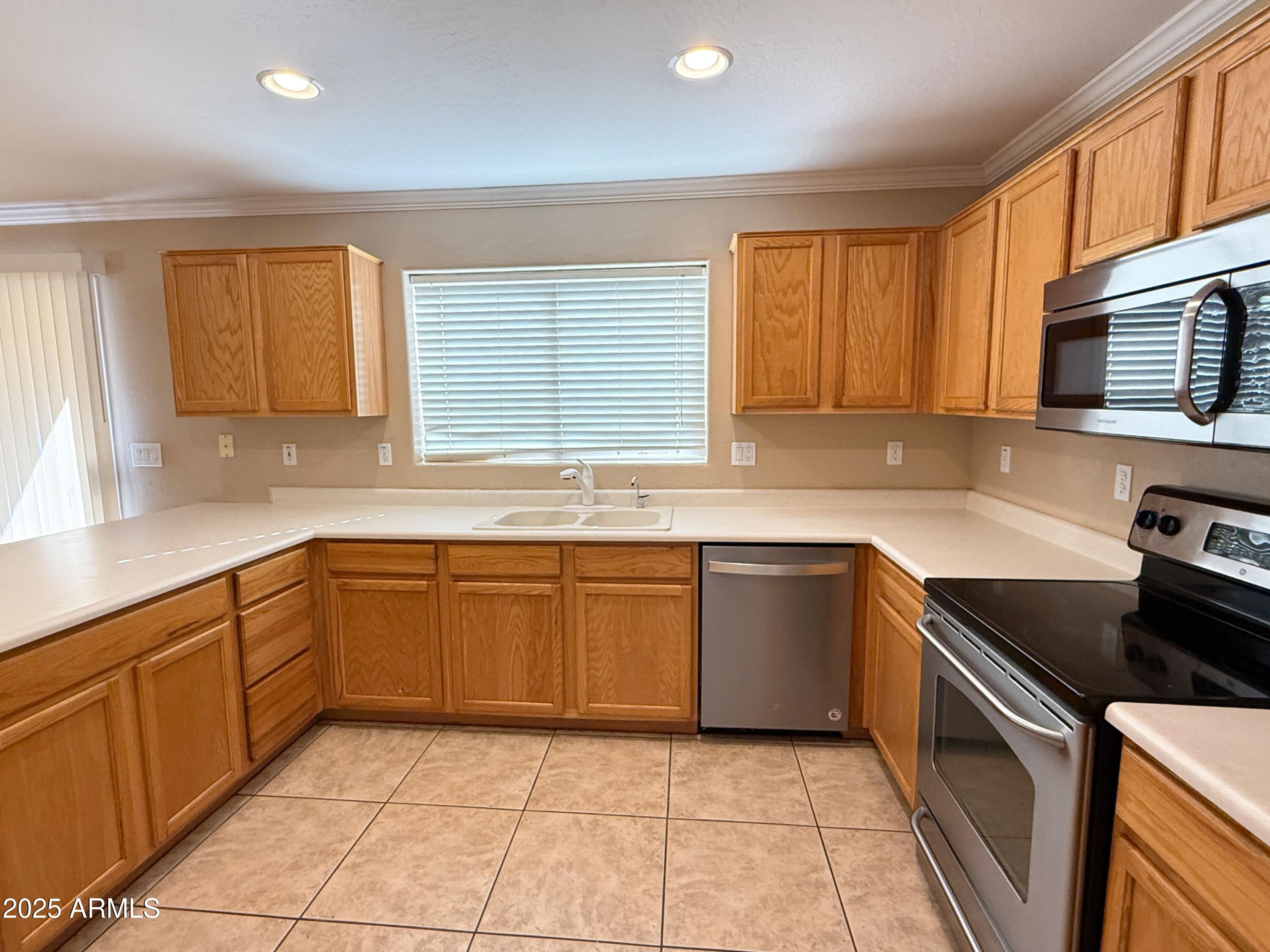 3363 East Flamingo Court Gilbert, AZ 85297 - Photo 10 of 29 a kitchen with stainless steel appliances granite countertop a sink and cabinets