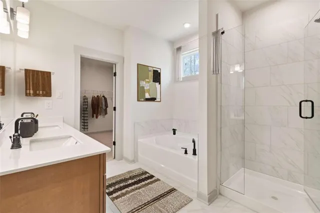 a bathroom with a tub sink and mirror