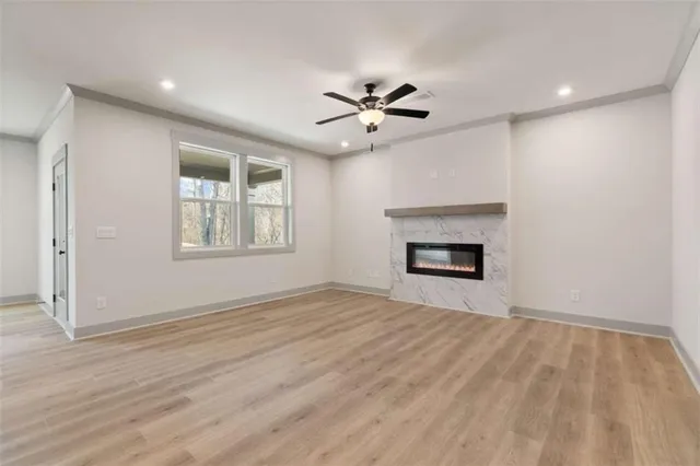 a view of an empty room with a window and fireplace