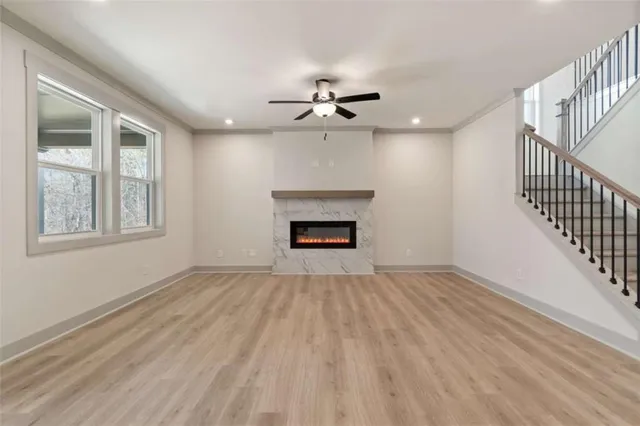 a view of an empty room with a fireplace and a window