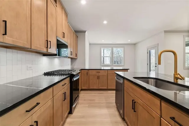 a kitchen with granite countertop a sink and cabinets