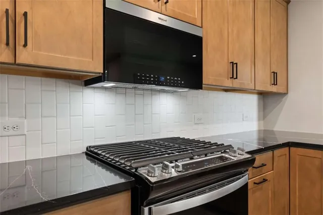 a stove top oven sitting inside of a kitchen