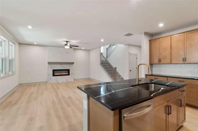 a kitchen with kitchen island a sink stainless steel appliances and cabinets