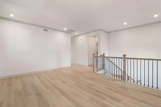 an empty room with windows and closet