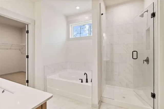 a white bath tub sitting next to a shower