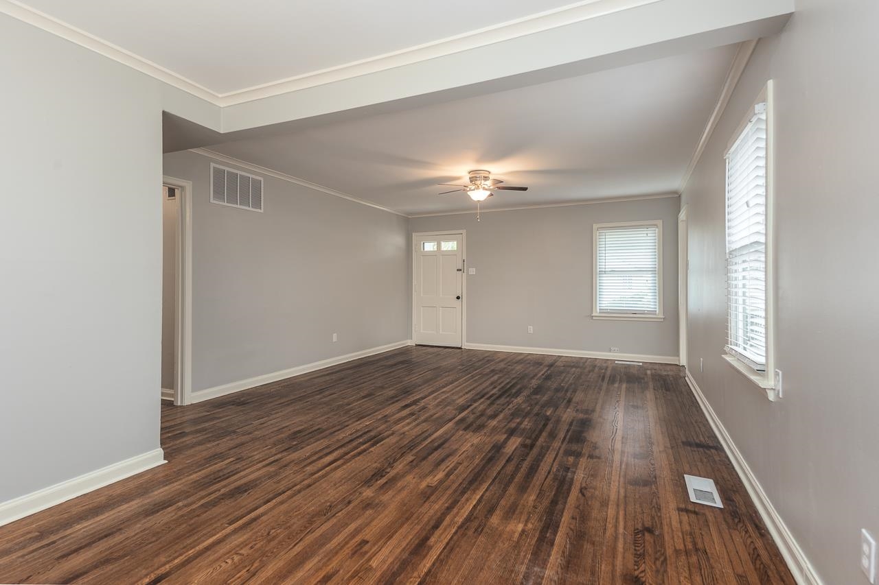 1368 South Perkins Road Memphis, TN 38117 - Photo 5 of 21 a view of an empty room with wooden floor and window